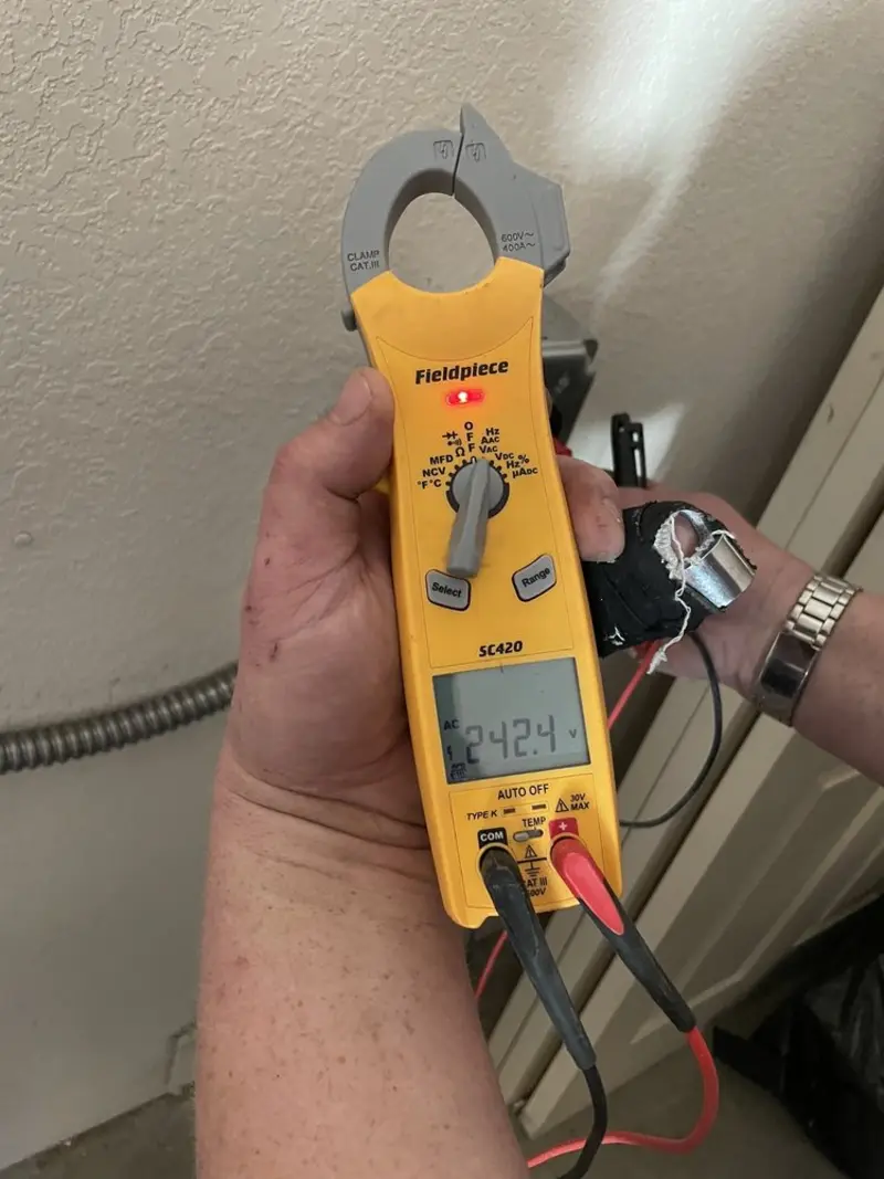 Voltage testing with clamp meter during Outlet Installation in Douglasville